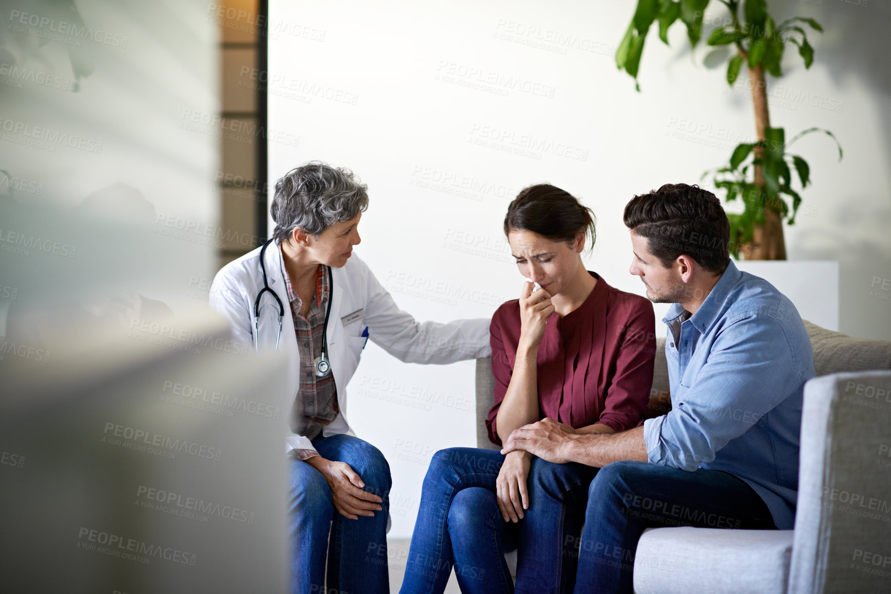 Buy stock photo Doctor, hospital and sad couple with bad news for cancer, health concern or treatment fail. Woman, healthcare worker or surgeon talking with empathy, support or understanding for family loss or grief
