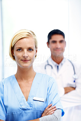 Buy stock photo Portrait of a female doctor with a colleague in the background