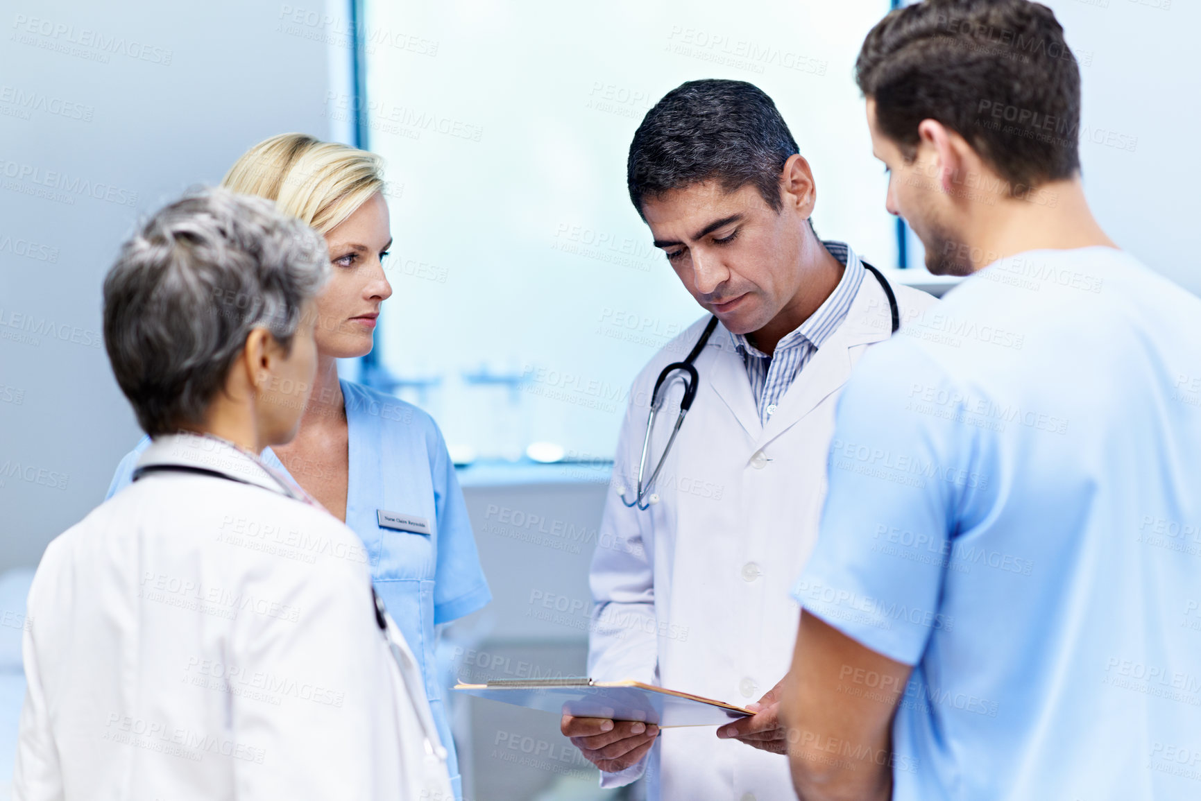 Buy stock photo Doctors, reading and group with paperwork in hospital, teamwork and discussion with patient records. Clinic, medical professional and people with documents, review or collaboration for treatment plan