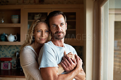 Buy stock photo Shot of an affectionate couple in their home