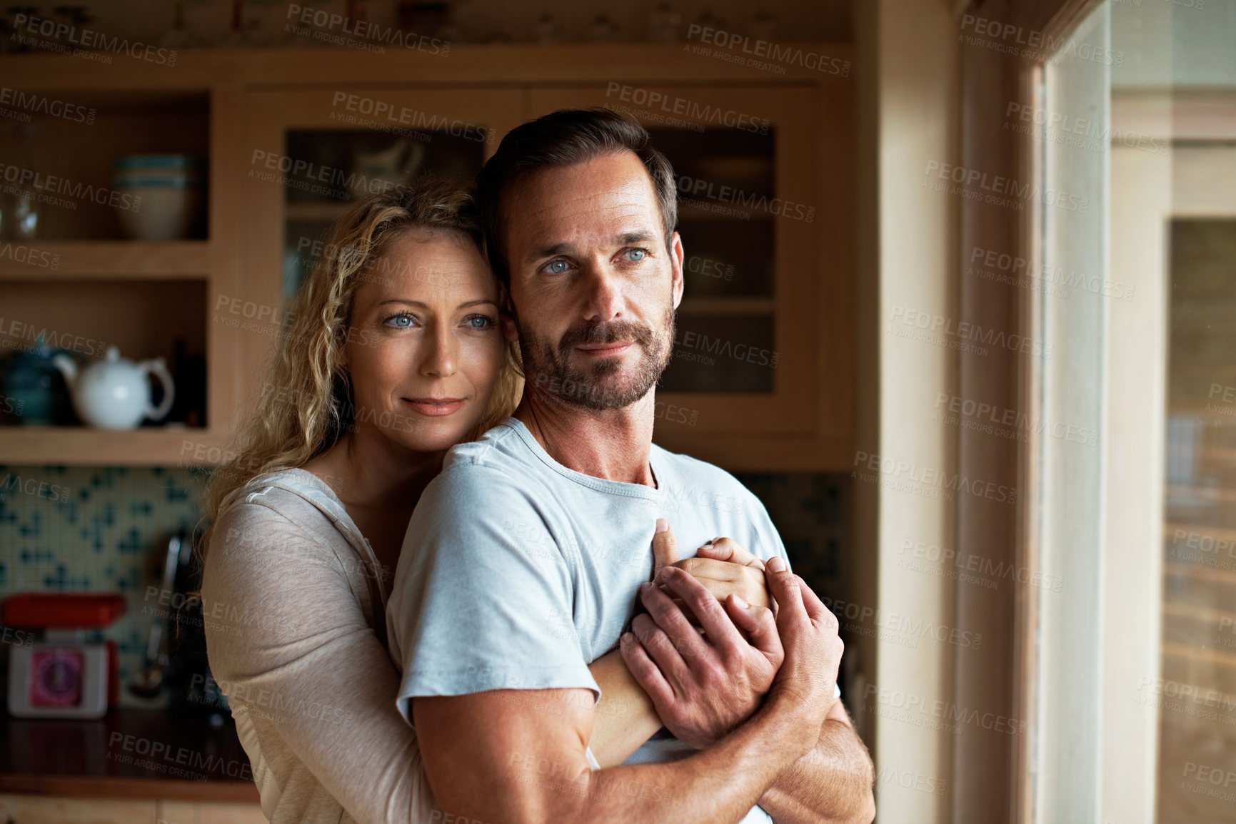 Buy stock photo Shot of an affectionate couple in their home