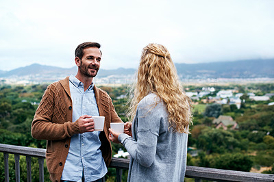 Buy stock photo Shot of a couple having a conversation on a balcony