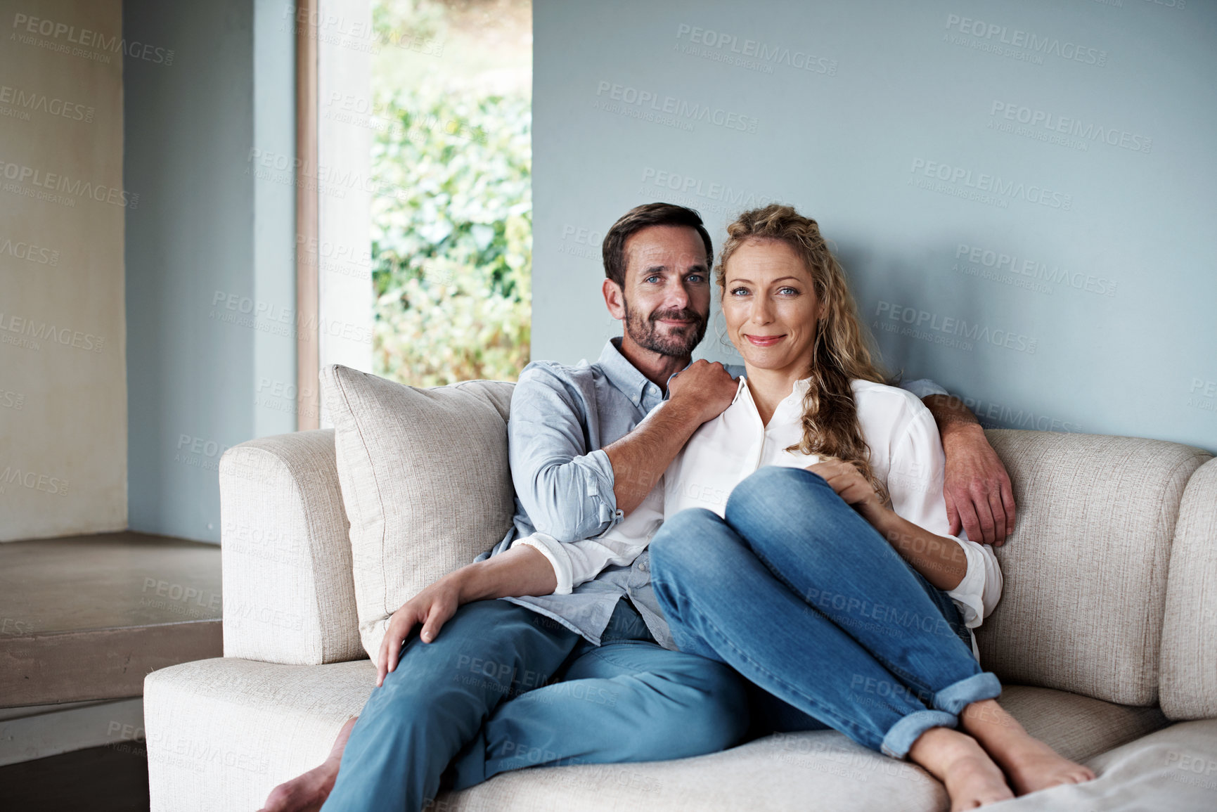 Buy stock photo Shot of an affectionate couple in their home
