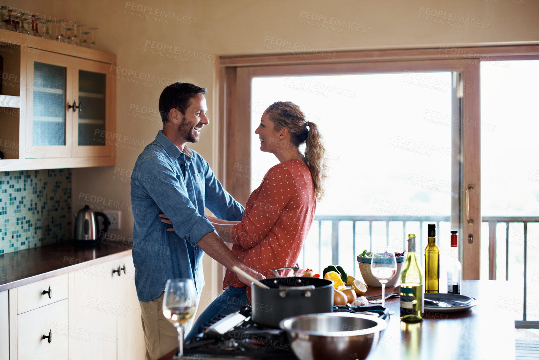 Buy stock photo Shot of a happy couple preparing a meal at home