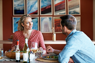 Buy stock photo Cropped shot of a couple having dinner together at home