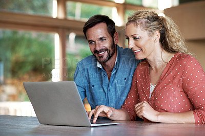 Buy stock photo Shot of a couple using a laptop at home