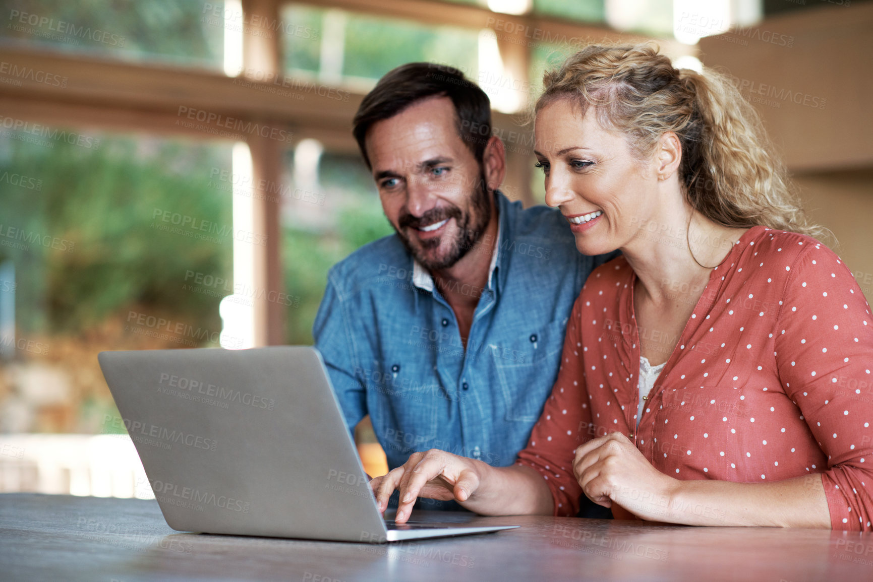 Buy stock photo Shot of a couple using a laptop at home