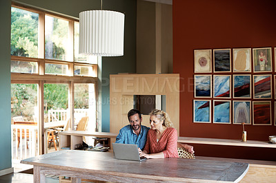 Buy stock photo Shot of a couple using a laptop at home