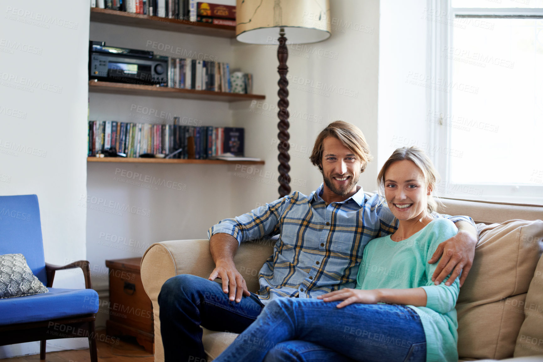 Buy stock photo Shot of a loving young couple relaxing on a sofa at home