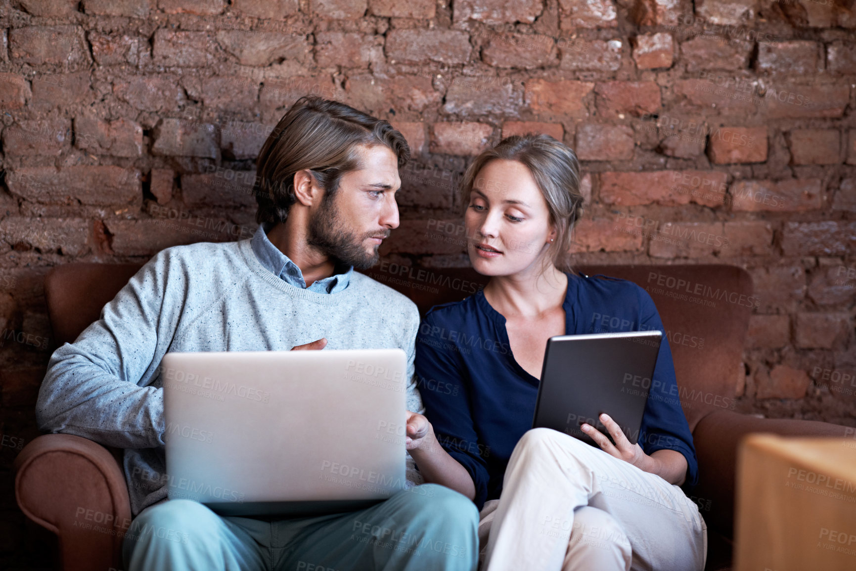 Buy stock photo Couple, tablet and laptop on sofa with conversation, browsing or streaming online for bonding. Man, woman and technology with relax in home, network and subscription with discussion on break together