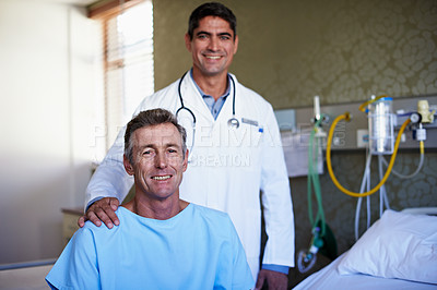 Buy stock photo Portrait of a doctor standing behind a patient sitting on a hospital bed