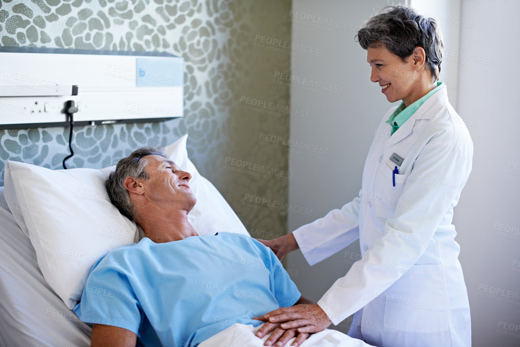 Buy stock photo Hospital, consulting and doctor with man in bed for support, surgery results and feedback. Healthcare, talking and woman with patient for conversation with health review, wellness and medical service