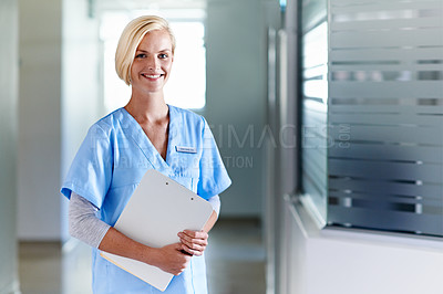 Buy stock photo Portrait of a young nurse standing in a hospital corridor