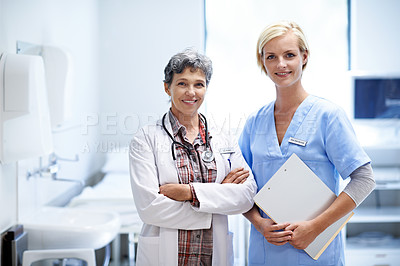Buy stock photo Portrait of two confident medical professionals standing together in a hospital