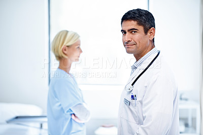 Buy stock photo Shot of two medical professionals standing in a hospital ward