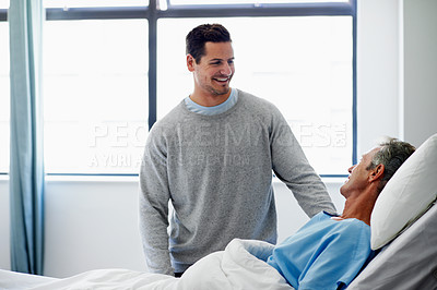 Buy stock photo Shot of a sun visiting his father in hospital