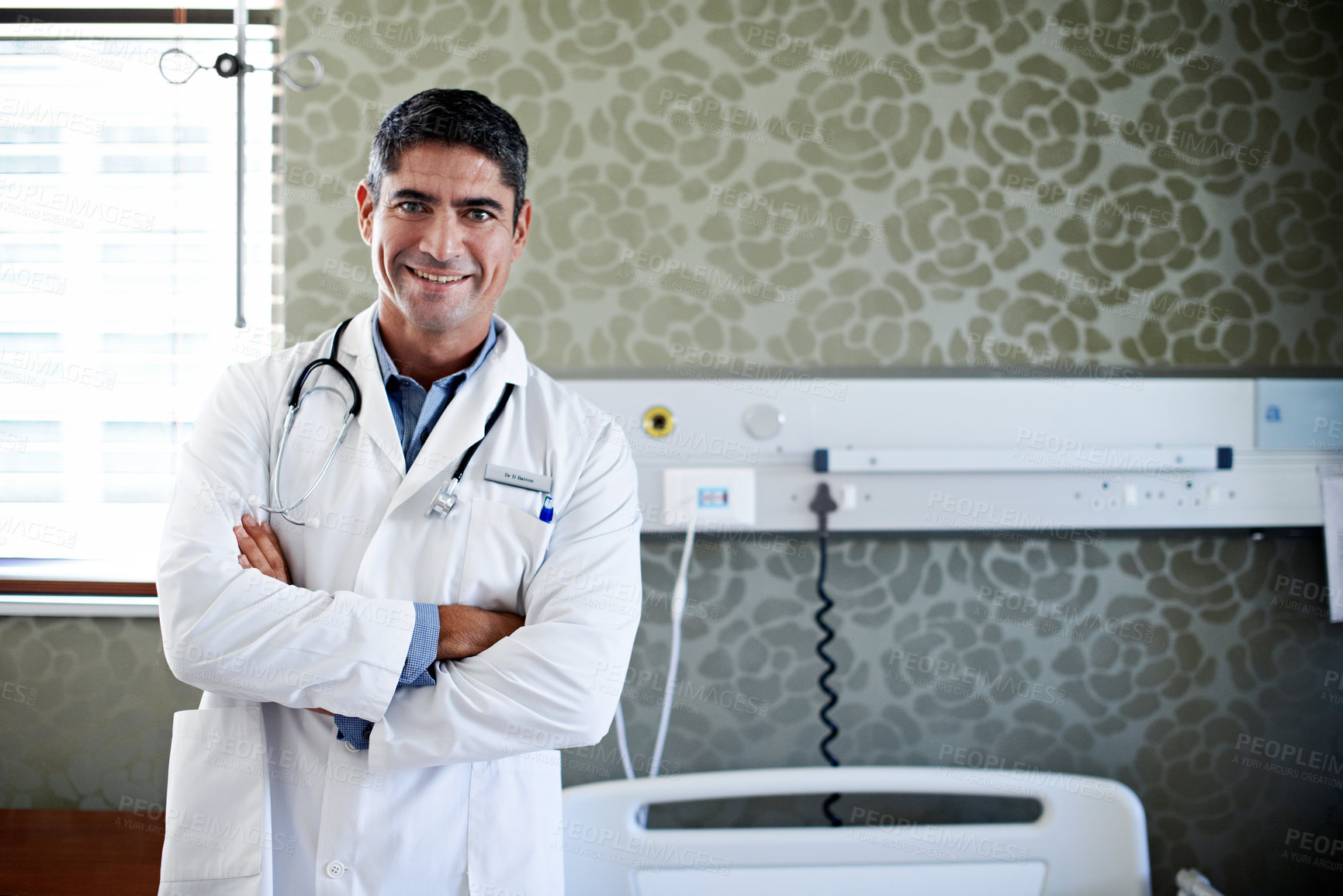 Buy stock photo Doctor, portrait and man with arms crossed in hospital, health services and pride for career growth. Clinic, healthcare professional and happy person with medical duty and confident with wellness job
