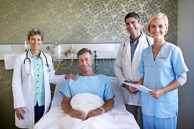 Buy stock photo Portrait of a team of medical professionals standing around a patient in a hospital bed