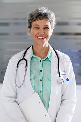 Buy stock photo Portrait of a mature female doctor standing in a hospital corridor