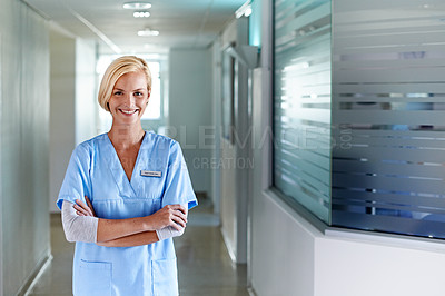 Buy stock photo Portrait of a young nurse standing in a hospital corridor