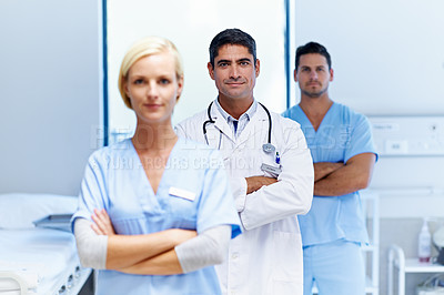 Buy stock photo Portrait of three medical professionals standing in a hospital ward