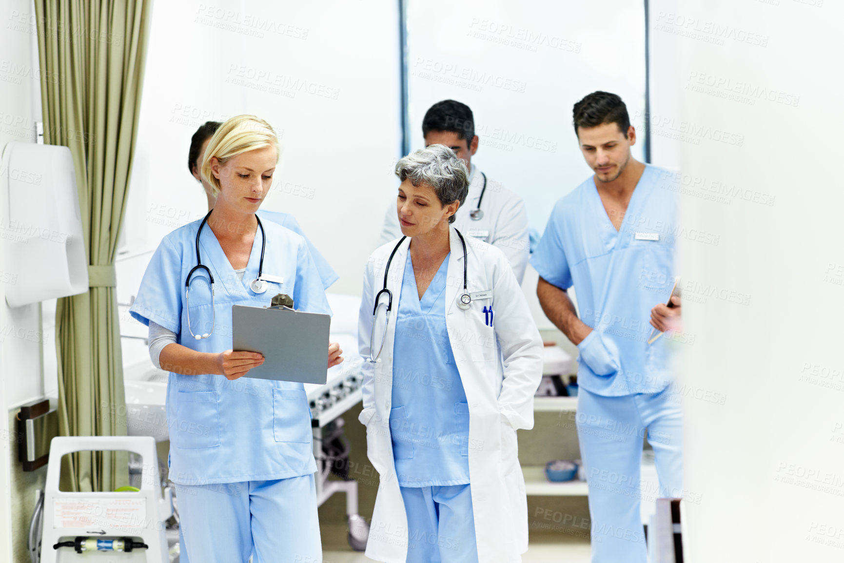 Buy stock photo Hospital, doctors and women with clipboard, help and talking with intern for treatment plan or info. Medical professional, mentor and people with checklist, collaboration and reading health report