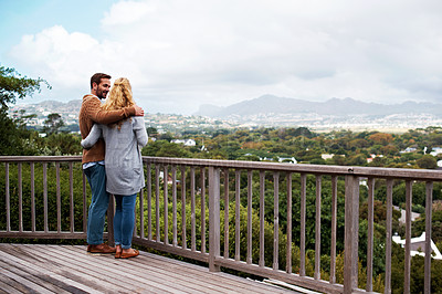 Buy stock photo Full length shot of a couple standing on a balcony