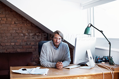 Buy stock photo Portrait of a young man working on his computer in his home study