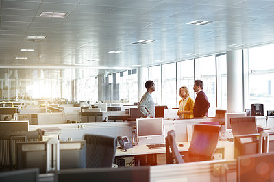 Buy stock photo Shot of a group of businesspeople talking together in an office