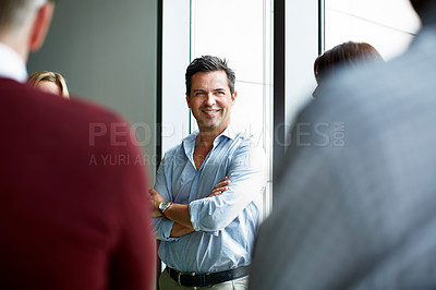 Buy stock photo Shot of a group of colleagues talking together in a modern office