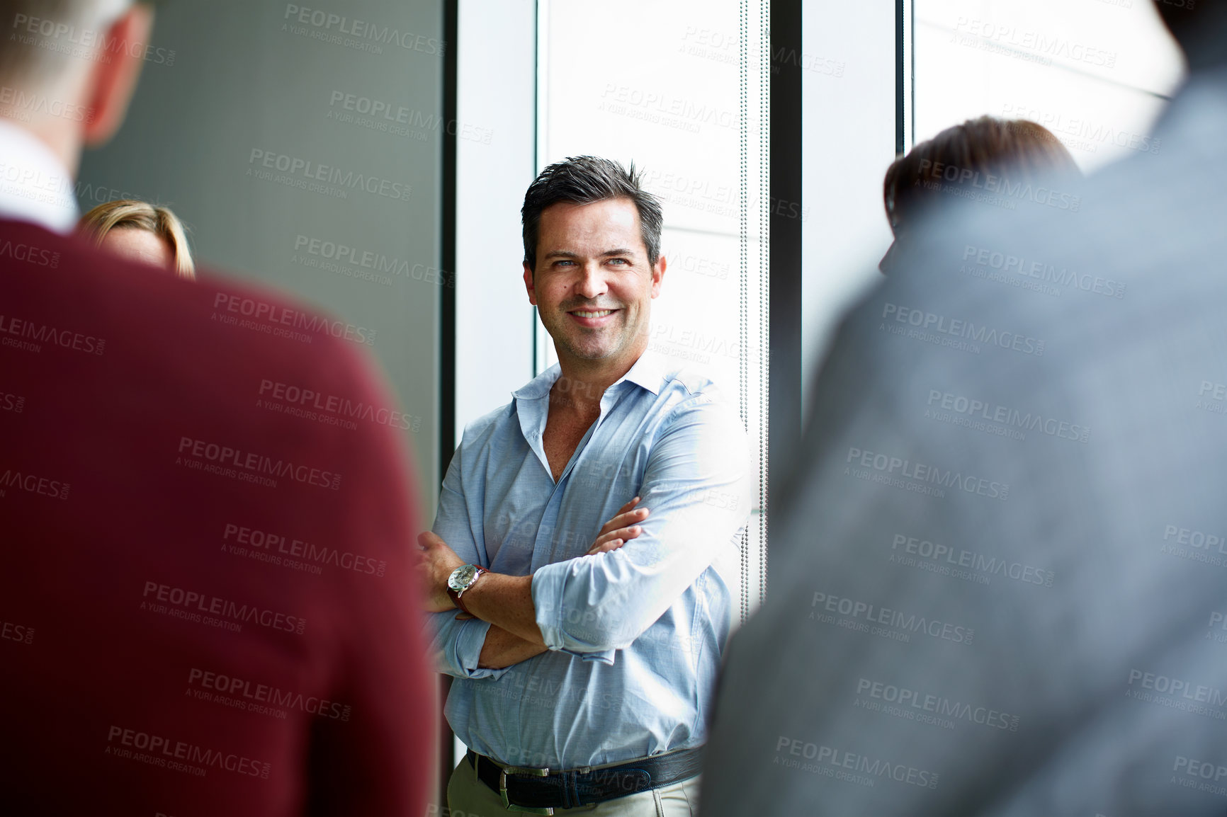 Buy stock photo Shot of a group of colleagues talking together in a modern office