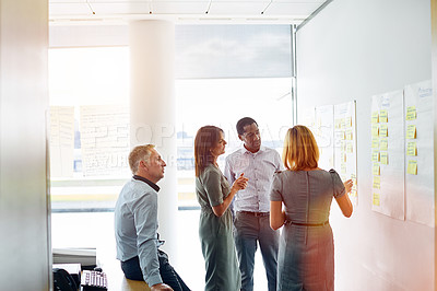 Buy stock photo Shot of a group of colleagues talking together in a modern office