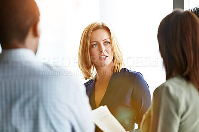 Buy stock photo Shot of a group of coworkers talking together while sitting in an office