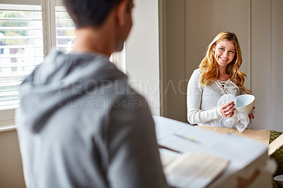 Buy stock photo Shot of a happy young couple unpacking boxes in their new house
