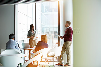 Buy stock photo Shot of a group of businesspeople talking together in an office
