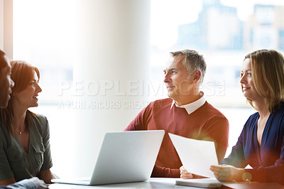 Buy stock photo Shot of a group of smiling coworkers having a meeting in an office