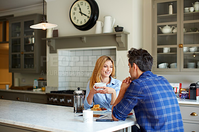 Buy stock photo Shot of a young couple having breakfast together at home