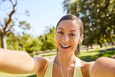 Buy stock photo Cropped portrait of an attractive and athletic young sportswoman taking selfies while out for a jog in the park