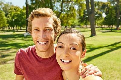Buy stock photo Cropped portrait of an affectionate and athletic young couple taking selfies while out for a jog in the park