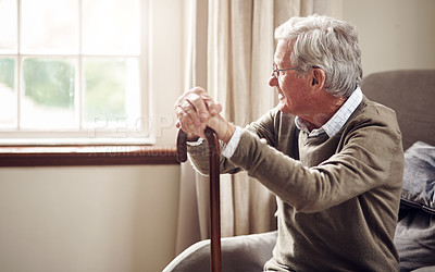 Buy stock photo Shot of a senior man looking thoughtfully out of a window at home