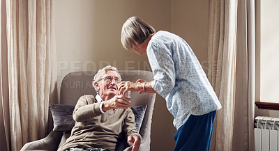 Buy stock photo Shot of a senior woman giving her husband medication with a glass of water