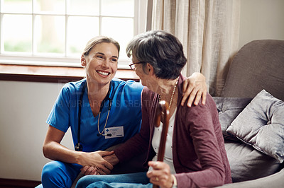 Buy stock photo Shot of a senior woman being cared for by a young nurse at home