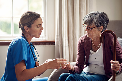 Buy stock photo Shot of a nurse giving a senior woman her medication at home