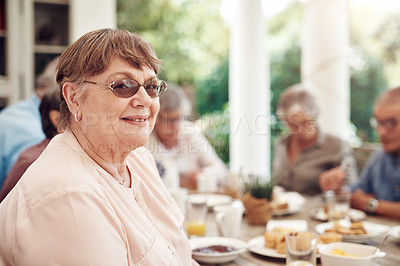 Buy stock photo Cropped portrait of a happy senior woman sitting and enjoying a tea party with her friends outdoors