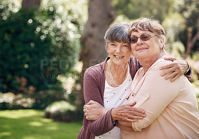 Buy stock photo Cropped portrait of two senior women holding each other during a day out in the garden