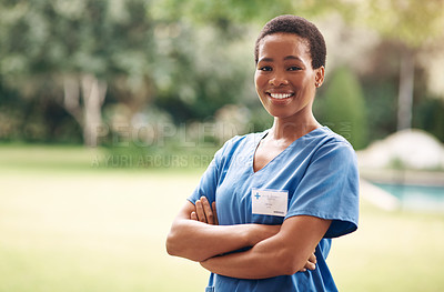 Buy stock photo Portrait of a confident young nurse standing outside in the garden of a retirement home
