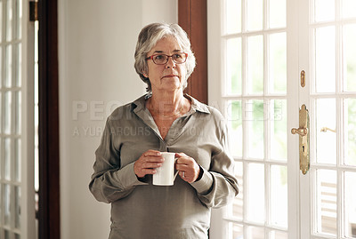Buy stock photo Shot of a senior woman having coffee and looking thoughtfully out of a window