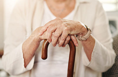 Buy stock photo Cropped shot of a senior woman using a walking stick at home