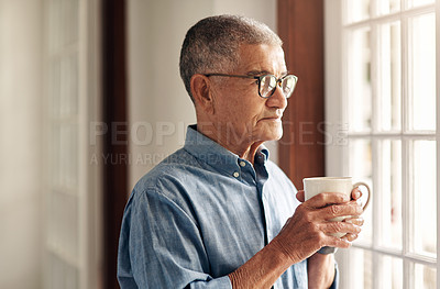 Buy stock photo Shot of a senior man having coffee and looking thoughtfully out of a window