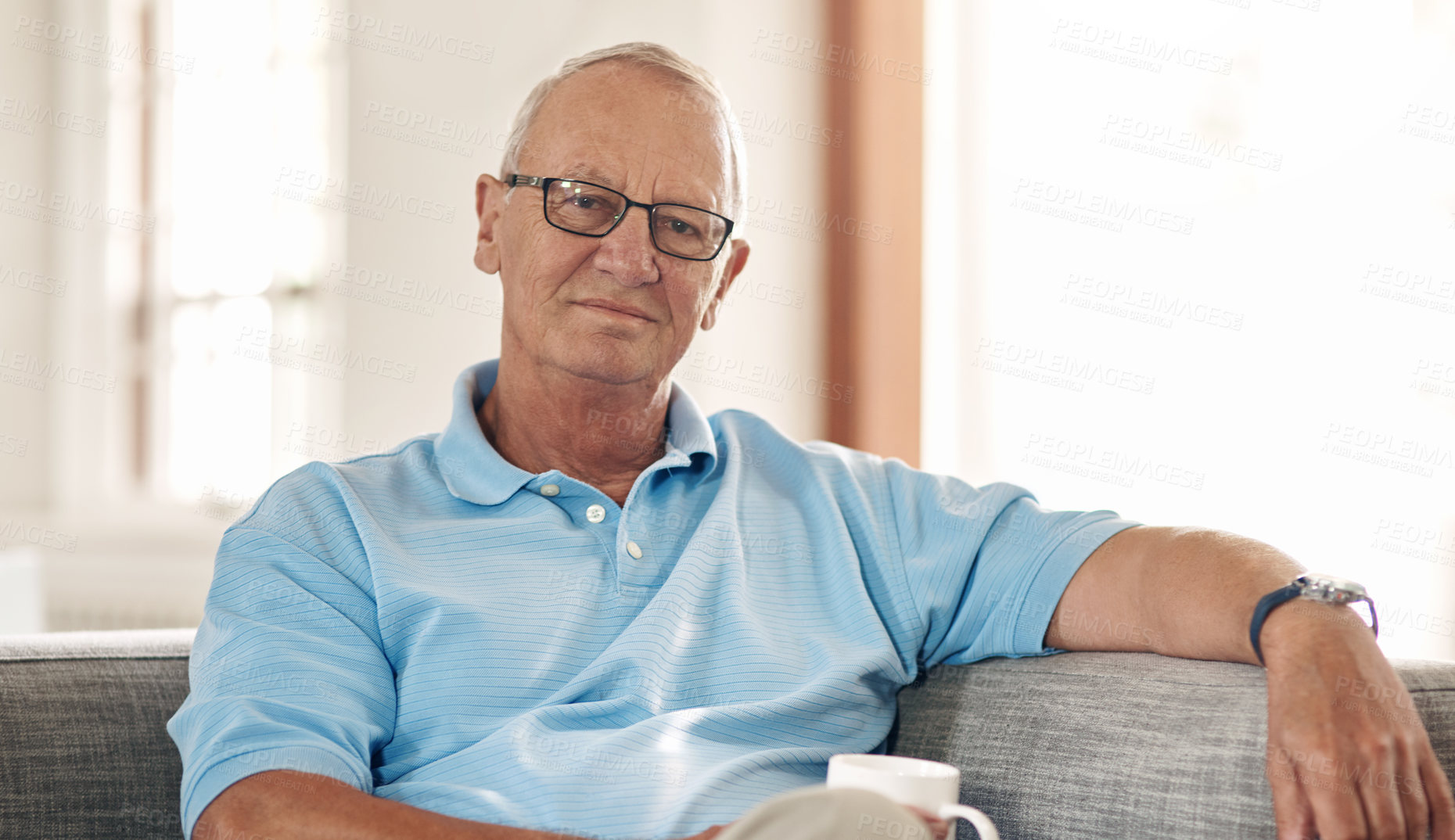 Buy stock photo Senior, man and portrait with coffee on sofa for peaceful morning, comfort and me time in lounge. Calm, old person and relax with tea for wellness, independent living and solitude in retirement home